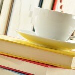 Composition with stack of books and cup of coffee